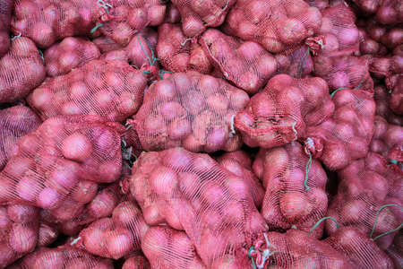 Onions inside bags in the supermarket.の写真素材