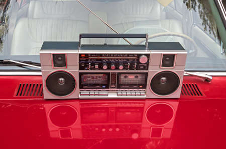 Device for sound playback and recording is on the hood of a retro car.の写真素材