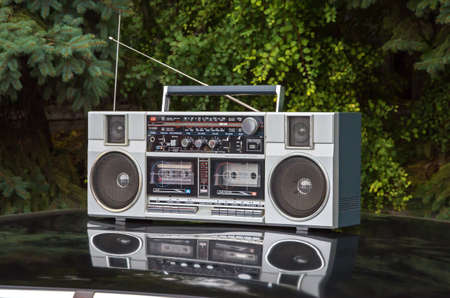 Device for sound playback and recording is on the roof of a retro car.の写真素材