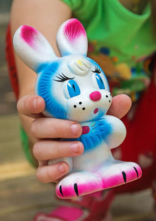 Old rubber toy in form of a colored rabbit for young childrenの写真素材