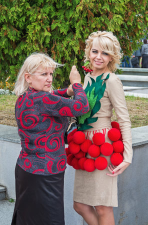 Dnepropetrovsk, Ukraine - September 14, 2013: Fashion designer prepares the model for exit at the podiumのeditorial素材