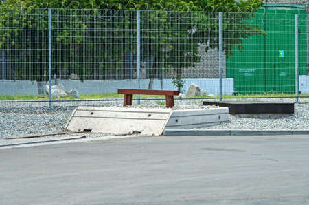 End of rail in an industrial area on against the background of a fence with barbed wire