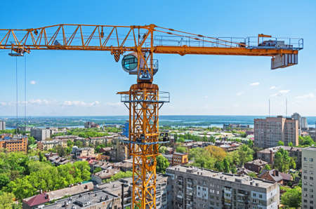 View of crane with a under construction skyscraper on background of the cityの写真素材