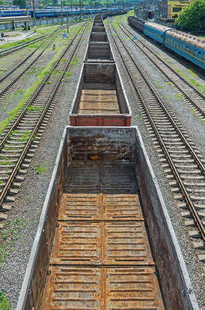 View of a moving railway freight train with a pedestrian bridgeの写真素材