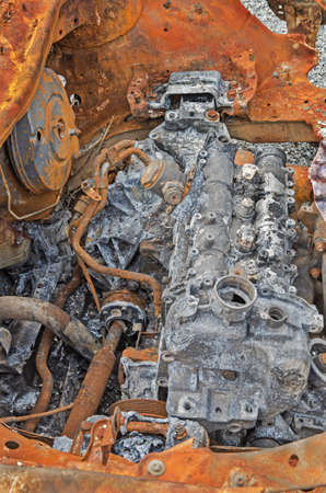 Destroyed and rusty car engine in a terrorist explosion and fire