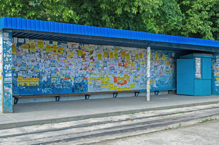 Dnipro, Ukraine - June 03, 2016: Public transport stop taped private adsのeditorial素材