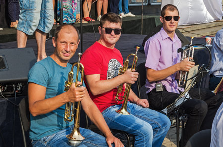 Dnipro, Ukraine - August 21, 2020: Cheerful trumpeters at rehearsal of the orchestra in open air on summer sunny dayのeditorial素材