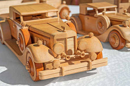 Wooden model of retro executive cars on a white backgroundの写真素材