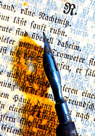 Old time pen throws shadow on Gothic script page detailの写真素材