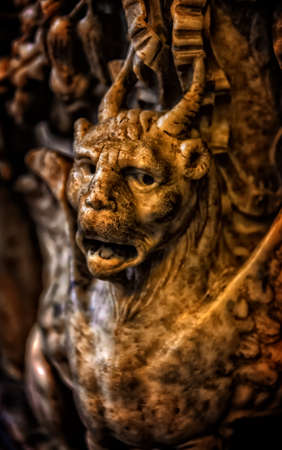 The devil sculpture from the cathedral in Sienaの写真素材