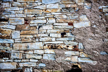 Traditional old stone wall with the rest of the plasterの写真素材