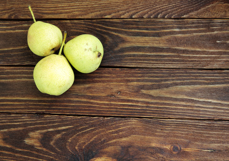 Three ripe pears on rustic tableの写真素材
