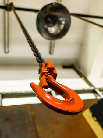 Big metal hook with chain isolated orange