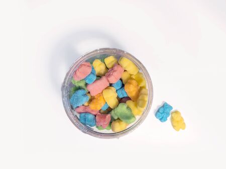 Flat lay of CBD infused medicinal sour candy gummies used for healing on a plain white backgroundの写真素材