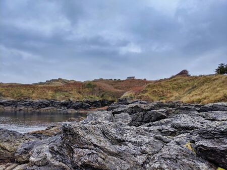 Breathtaking view of the scenic, coastal shoreline of San Juan Island, WA, on a cloudy, blue dayの写真素材