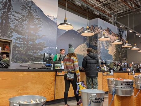 Bellevue, WA / USA - circa November 2019: People approaching the cash register inside an REI Co-Op to make an outdoors and recreation purchase.のeditorial素材