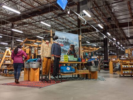 Bellevue, WA / USA - circa November 2019: People browsing outdoors and recreation clothing and accessories inside of an REI Co-Op.のeditorial素材