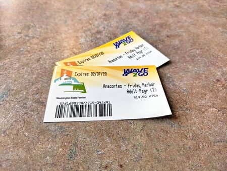 San Juan Island, WA / USA - November 8th, 2019: Wave 2 Go Washington State Ferries adult passenger tickets on a table inside the Anacortes Ferry.のeditorial素材