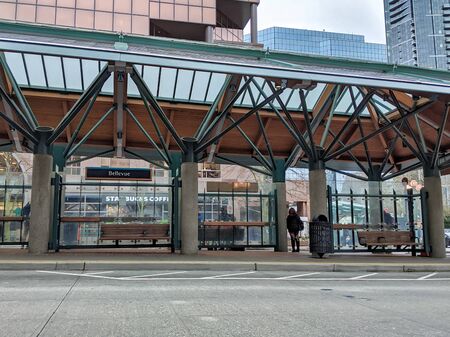Bellevue, WA / USA - circa December 2019: Person waiting at the Bellevue Transit Center for a metro bus to arrive.のeditorial素材