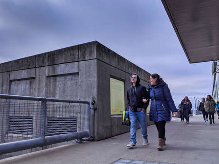 Seattle, WA / USA - circa November 2019: Several people fishing and viewing the landscape from the...