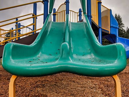 Low angle view of a colorful playground slide after a rainy day in the pacific northwest