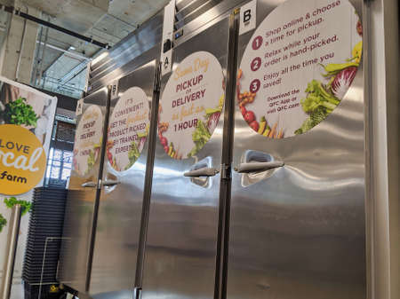 Kirkland, WA / USA - circa March 2020: Low angle view of online order storage shelves inside a QFC grocery store.のeditorial素材