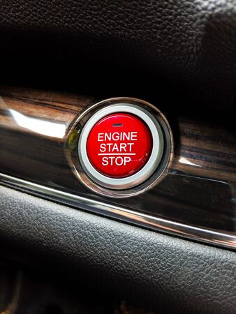 Macro, selective focus on a bright red push start button for keyless car ignition
