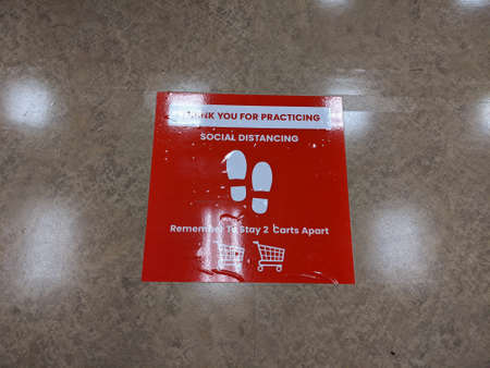 Kirkland, WA / USA - circa March 2020: Signs instructing social distancing at the self checkout...