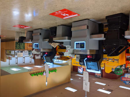 Kirkland, WA / USA - circa March 2020: Signs instructing social distancing at the self checkout...