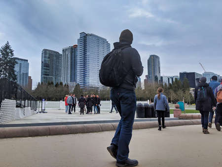 Bellevue, WA / USA - circa December 2019: Group of people walking around in the park in downtown...