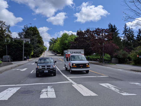 Kirkland, WA / USA - circa May 2020: Street view of a U-Haul moving truck stopped at a traffic light...