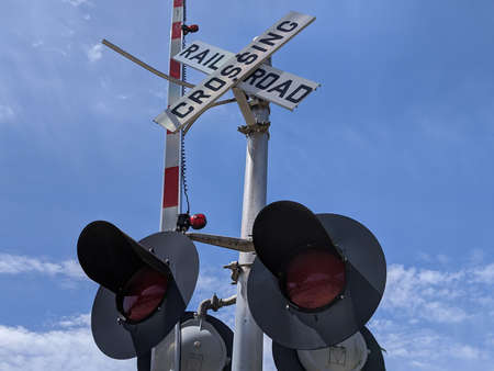 Low angle view of traffic lights at a railway crossroad in a quiet small town