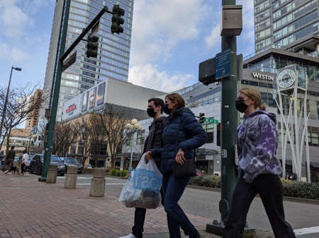 Redmond, WA USA - circa March 2021: Street view of people shopping in downtown Bellevue while wearing masks.のeditorial素材