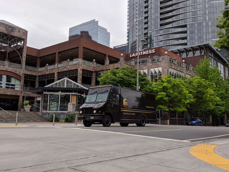Bellevue, WA USA - circa June 2020: Street view of a UPS delivery truck driving around downtown Bellevue, making deliveries.のeditorial素材