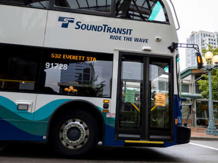 Bellevue, WA USA - circa June 2020: Street view of a Sound Transit metro bus parked at a curb in downtown Bellevue.のeditorial素材