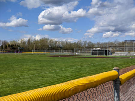 Angled view of a large, empty baseball field on a bright, sunny day