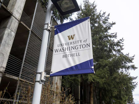 Bothell, WA USA - circa April 2021: Low angle view of a University of Washington Bothell banner on a pole outside the parking garage.のeditorial素材