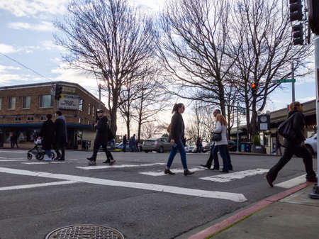 Kirkland, WA USA - circa January 2020: Street view of people crossing the street and shopping in downtown Kirkland.のeditorial素材
