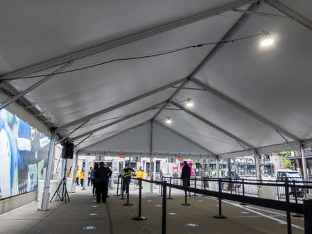 Seattle, WA USA - circa May 2021: View of people waiting in line for security checks before receiving the covid 19 vaccine at Lumen Fieldのeditorial素材