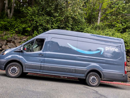 Seattle, WA USA - circa May 2021: Street view of an Amazon Prime delivery truck in a residential neighborhood.のeditorial素材