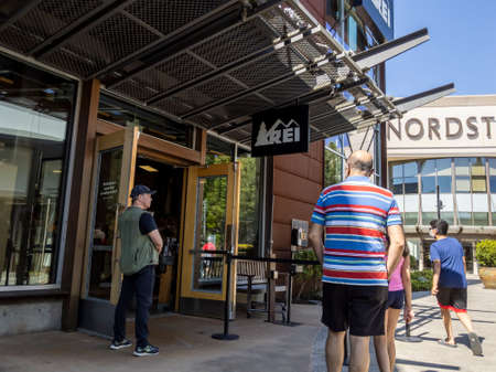 Lynnwood, WA USA - circa July 2021: View of people lining up outside of an REI store at the...