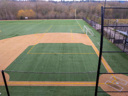 Angled view of a large, empty baseball field on an overcast dayの写真素材