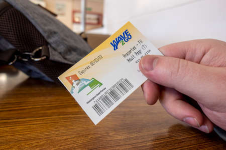 Anacortes, WA USA - circa November 2021: Person holding Wave 2 Go Washington State Ferries adult...