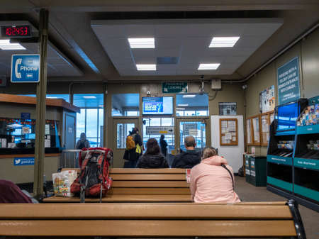 Anacortes, WA USA - circa November 2021: View of people sitting and standing, waiting for the...