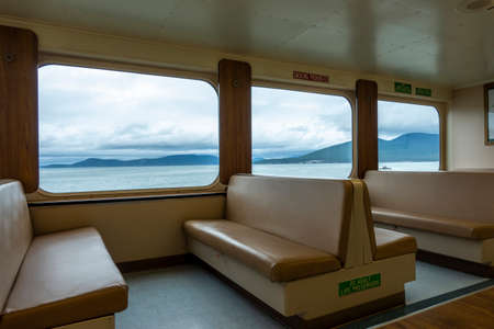 San Juan Island, WA USA - circa November 2021: Angled view of padded bench seating inside of a Washington State Ferry bound for Friday Harbor.のeditorial素材