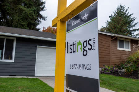 Kirkland, WA USA - circa October 2021: Angled view of a Listings.com real estate sign in the yard of a suburban house.のeditorial素材
