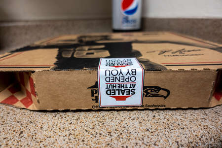 Seattle, WA USA - circa October 2021: Macro, selective focus on a Pizza Hut pizza box sitting on a...