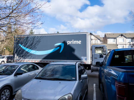 Seattle, WA USA - circa March 2022: Angled view of a large Amazon Prime semi-truck outside of an apartment complex on a bright, sunny day.のeditorial素材