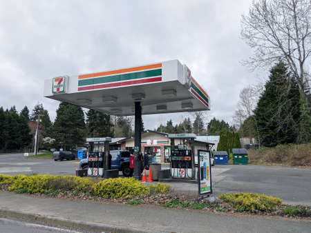Kirkland, WA USA - circa April 2021: Angled view of a 7 Eleven gas station at the corner of a small...