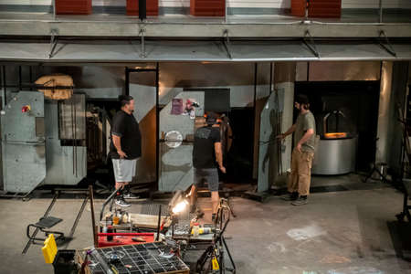 Tacoma, WA USA - circa August 2021: View of glass blowers doing a live demonstration at the Museum...